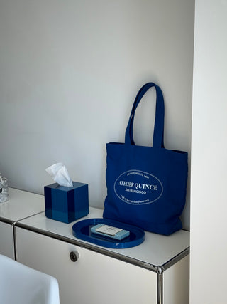 Rhapsody Blue tissue case and vanity tray on a shelf with Atelier Quince tote bag