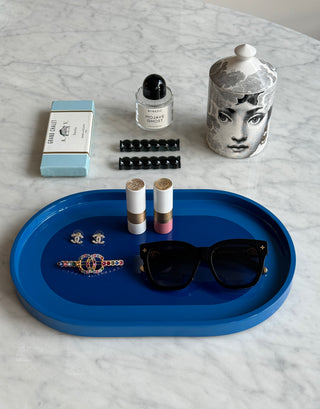 Rhapsody Blue Vanity Tray flat lay on marble with perfume, candle and sunglasses
