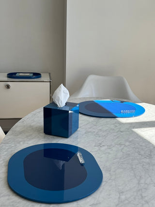 Rhapsody Blue placemats with crystal cutlery rests and tissue case on marble