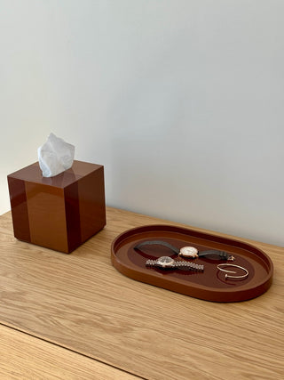 Rhapsody Brown tissue case and vanity tray with watches on an oak console