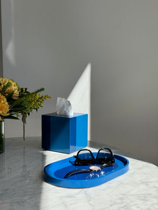 Rhapsody Blue tissue case and vanity tray in sunlight on a marble table