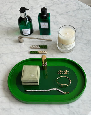 Rhapsody Green vanity tray with jewelry, candle and perfume on marble